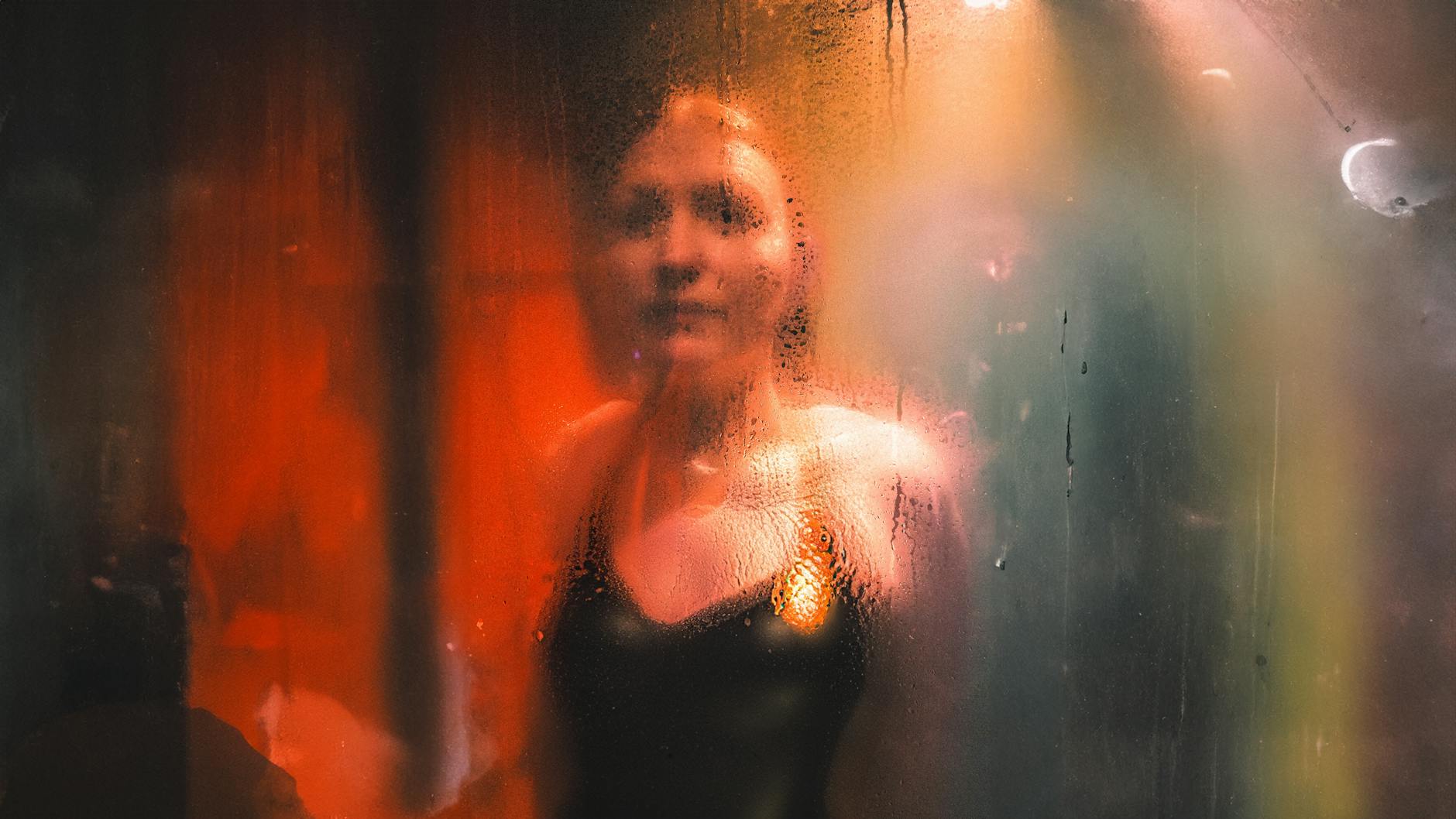 Abstract portrait of a person behind a steamy glass, creating a cinematic feel.