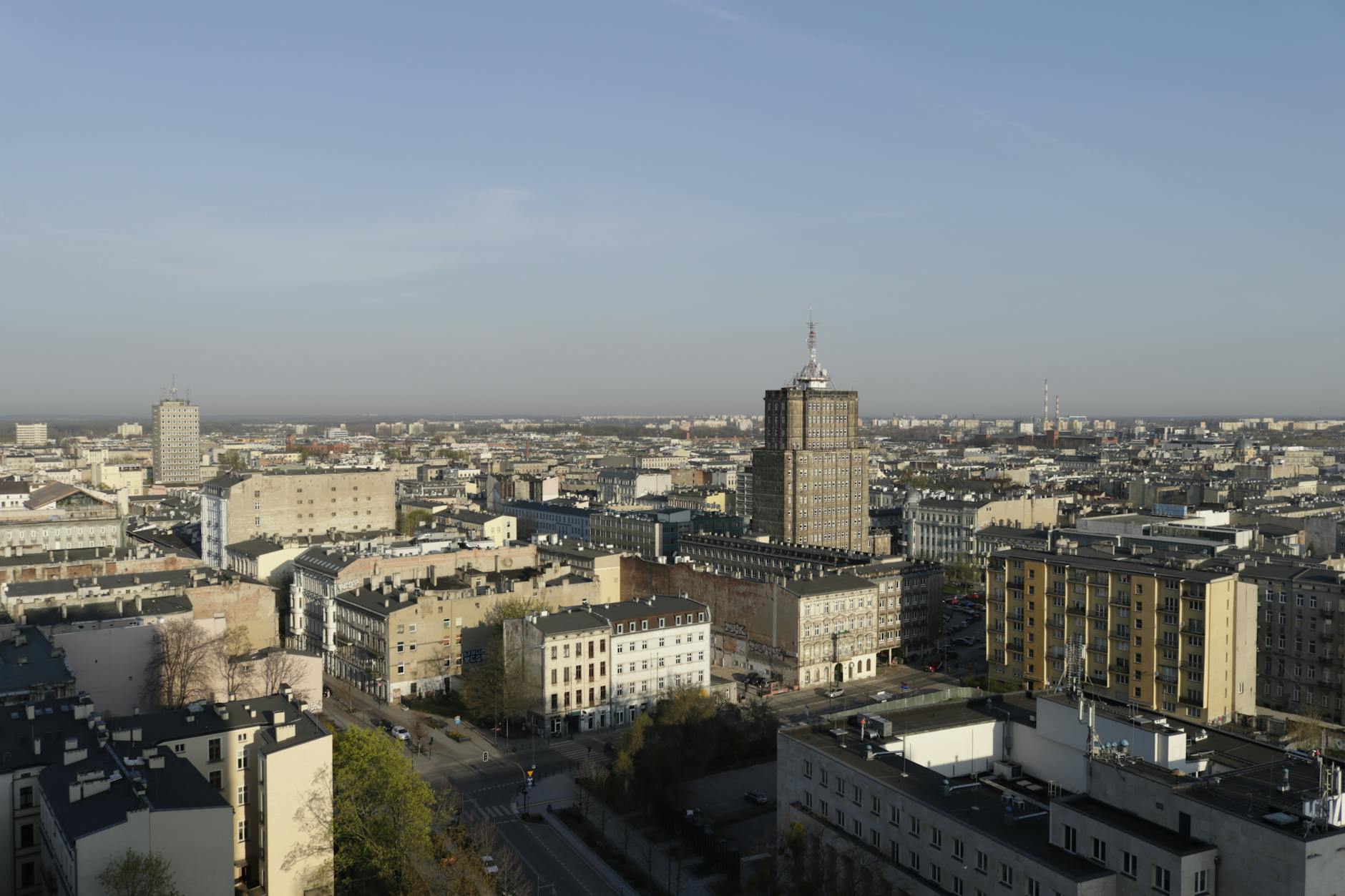 Aerial shot capturing a sprawling cityscape with varied architecture in daylight.