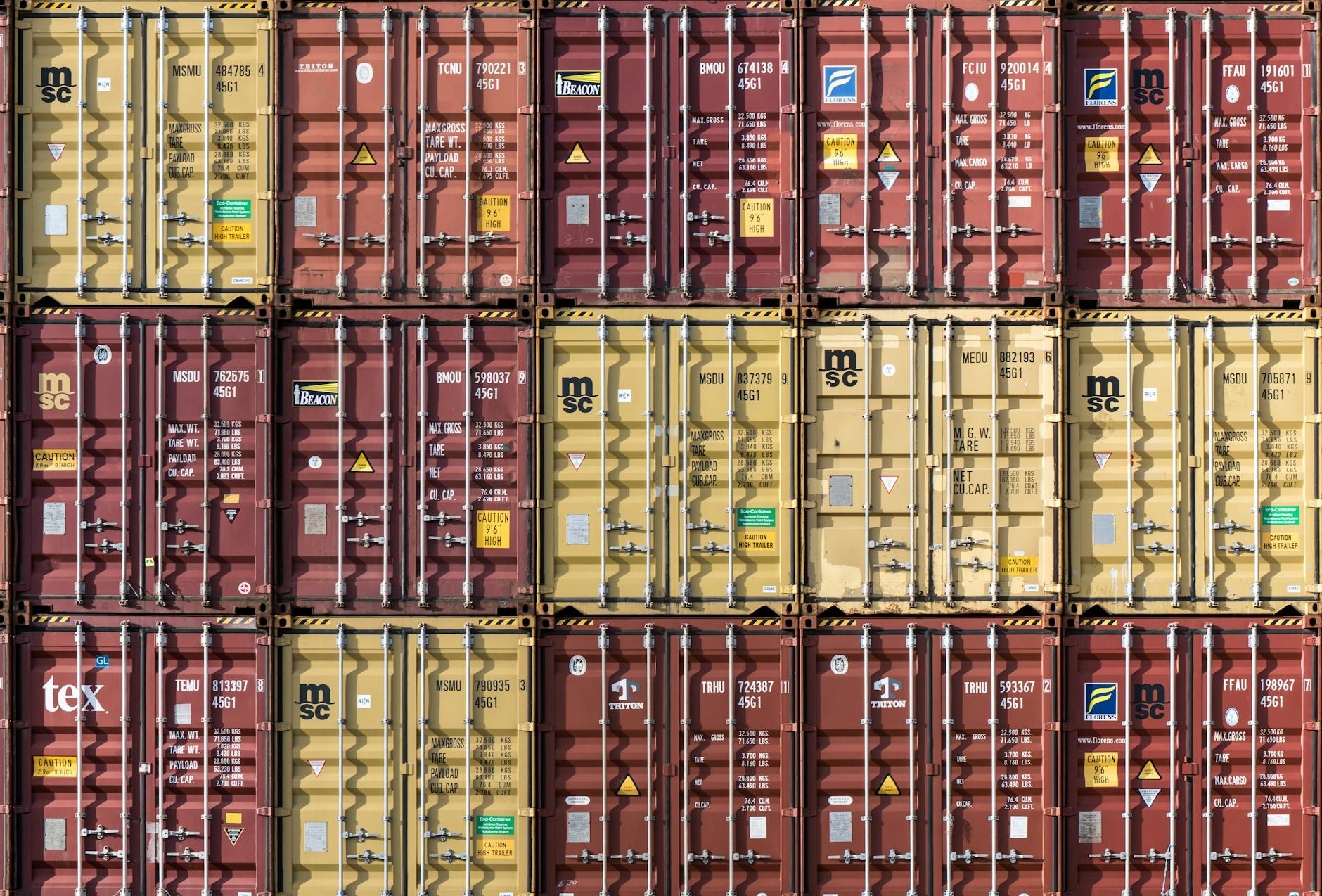 Rows of stacked shipping containers at Hamburg port. Industrial and international trade imagery.
