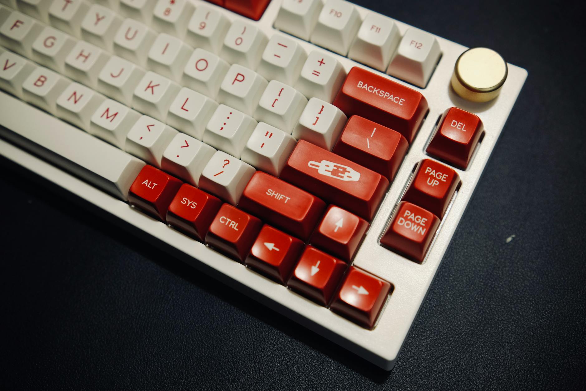 A detailed close-up image of a custom red and white mechanical keyboard.