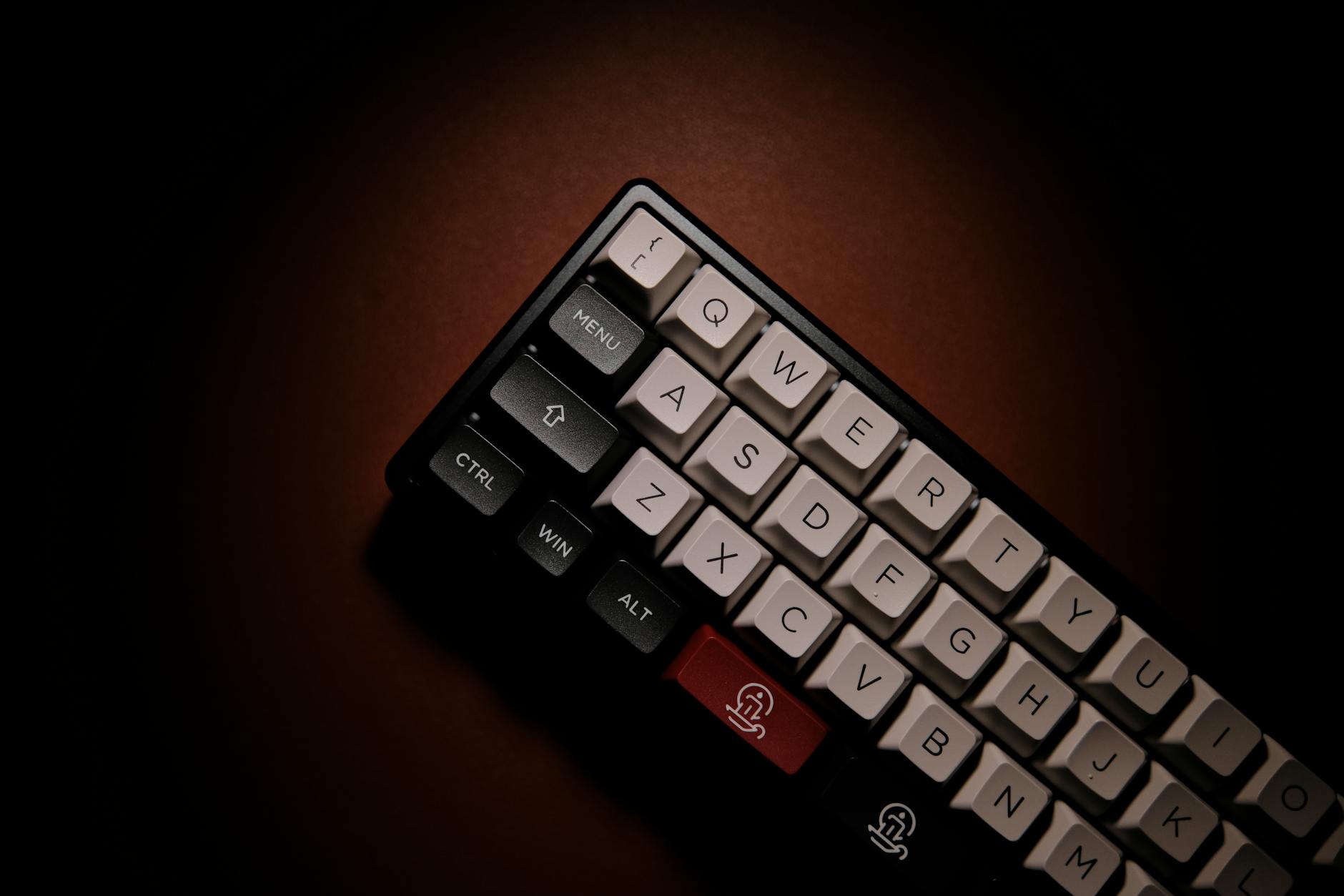Close-up shot of a mechanical keyboard with keycaps on a brown surface.