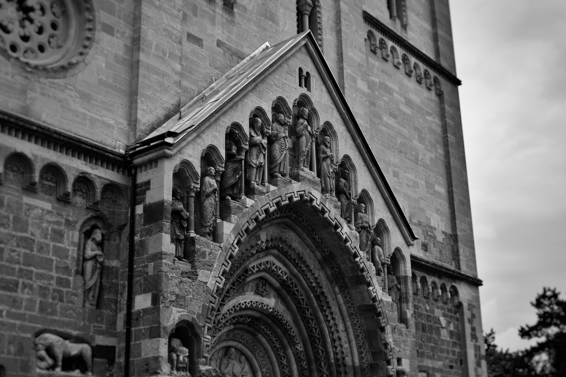 Vintage-style photograph capturing the intricate details of Ják Church's façade in Hungary.